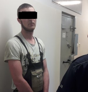 Mężczyzna na korytarzu policyjnego aresztu