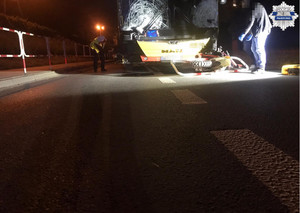 Autobus linii podmiejskiej stojący na drodze, rozbita przednia szybka autobusu, motocykl crossowy leży po prawej stronie