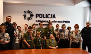 zdjęcie grupowe harcerzy oraz komendantów na tle napisu Komenda Powiatowa Policji w Piasecznie