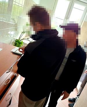 zatrzymany mężczyzna w trakcie pobierania od niego odcisków linii papilarnych